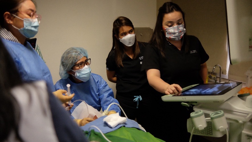 A group of nurses in a hospital room  Description automatically generated